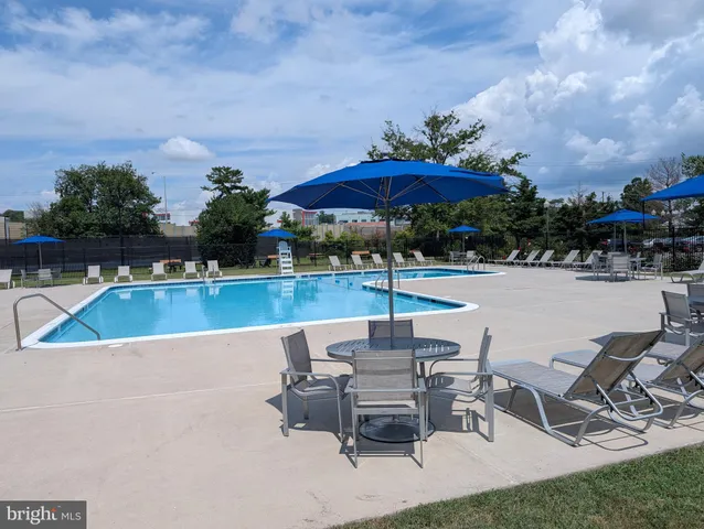 a view of a swimming pool with a patio and a garden