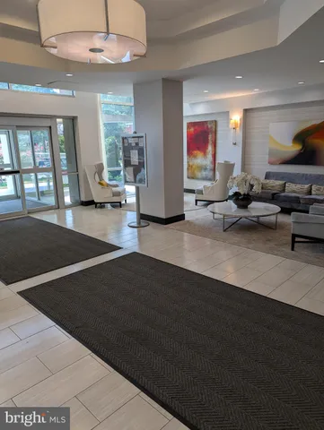 a living room with lots of furniture and a chandelier