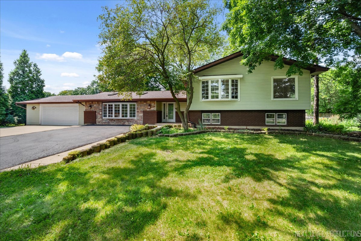 4N636 Klein Road West Chicago, IL 60185 - Photo 1 of 36 a view of a house with a yard and sitting area