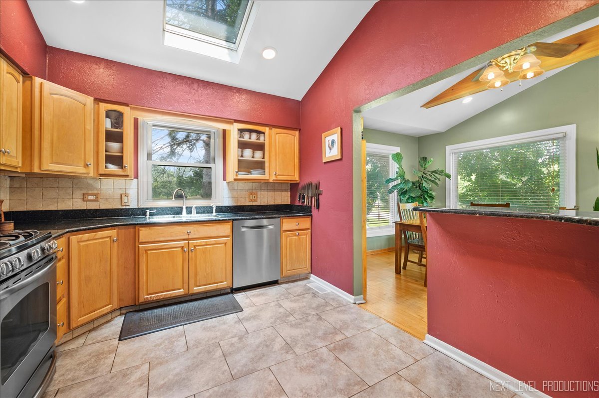 4N636 Klein Road West Chicago, IL 60185 - Photo 12 of 36 a kitchen with stainless steel appliances granite countertop a stove a sink and a microwave