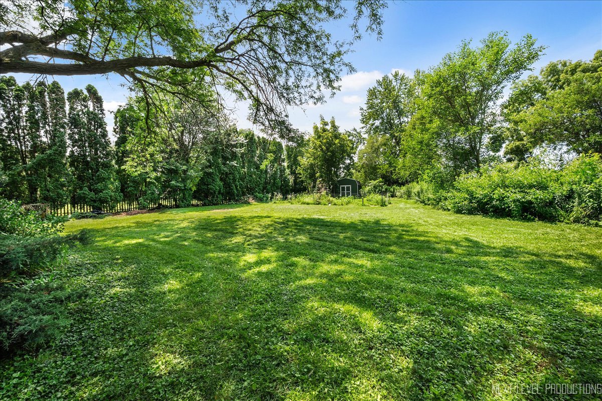 4N636 Klein Road West Chicago, IL 60185 - Photo 25 of 36 a backyard of a house with lots of green space and fountain