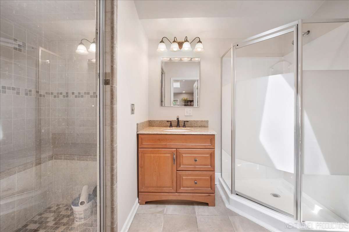 4N636 Klein Road West Chicago, IL 60185 - Photo 3 of 36 a bathroom with a shower a sink and a mirror