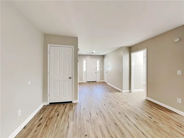 a view of an empty room and wooden floor
