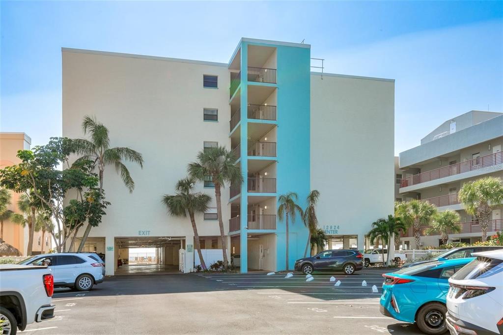 12924 Gulf Boulevard, Unit 510 Madeira Beach, FL 33708 - Photo 14 of 61 a view of a car park in front of a building