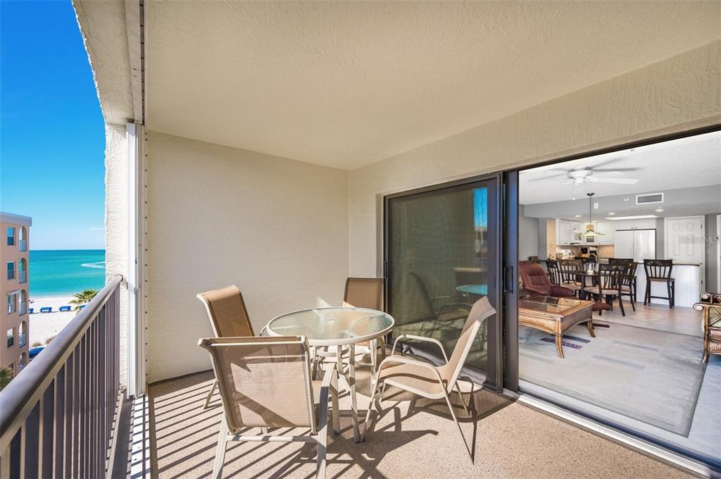 12924 Gulf Boulevard, Unit 510 Madeira Beach, FL 33708 - Photo 20 of 61 a view of a dining room with a table and chairs