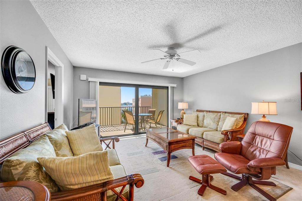12924 Gulf Boulevard, Unit 510 Madeira Beach, FL 33708 - Photo 24 of 61 a living room with furniture and a large window