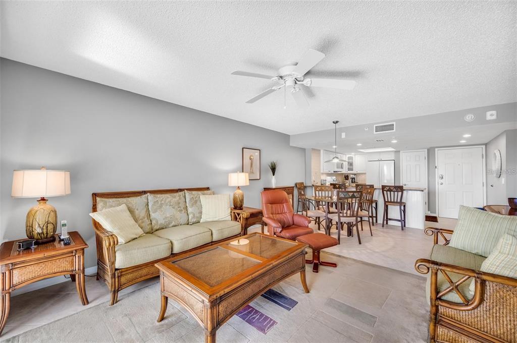 12924 Gulf Boulevard, Unit 510 Madeira Beach, FL 33708 - Photo 25 of 61 a living room with furniture and a chandelier