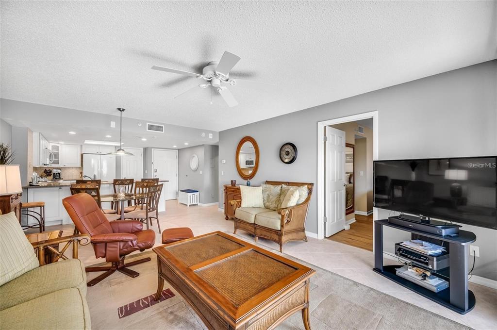 12924 Gulf Boulevard, Unit 510 Madeira Beach, FL 33708 - Photo 26 of 61 a living room with furniture and a flat screen tv