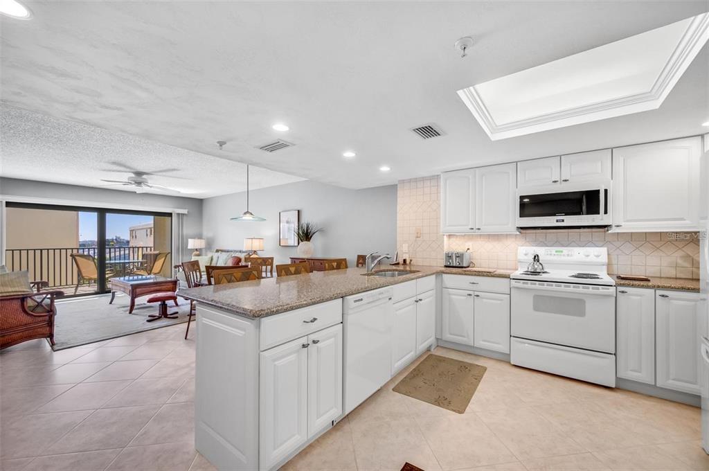 12924 Gulf Boulevard, Unit 510 Madeira Beach, FL 33708 - Photo 29 of 61 a kitchen with counter top space cabinets and appliances