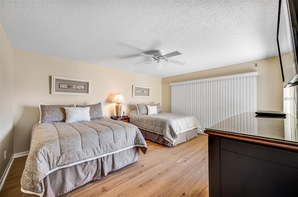12924 Gulf Boulevard, Unit 510 Madeira Beach, FL 33708 - Photo 32 of 61 a bedroom with two beds and a large window