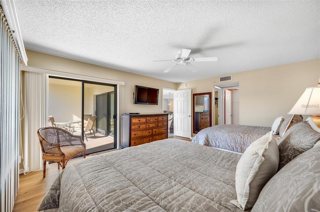 12924 Gulf Boulevard, Unit 510 Madeira Beach, FL 33708 - Photo 34 of 61 a bedroom with a bed and a television