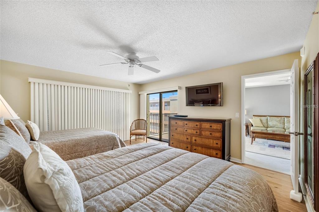 12924 Gulf Boulevard, Unit 510 Madeira Beach, FL 33708 - Photo 35 of 61 a bedroom with a bed and a television