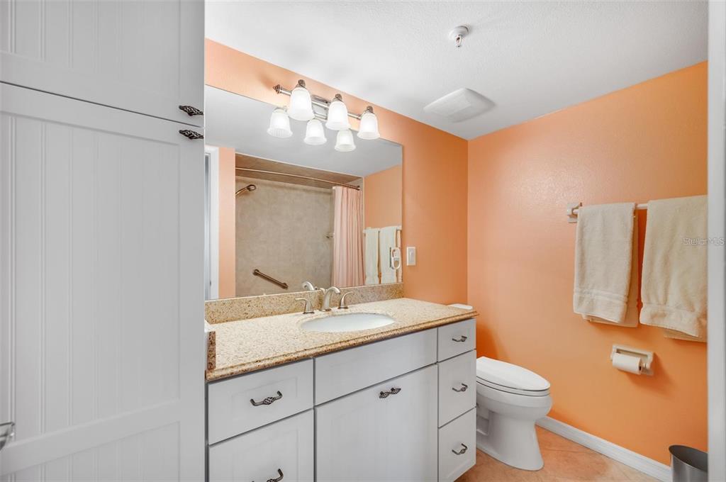 12924 Gulf Boulevard, Unit 510 Madeira Beach, FL 33708 - Photo 36 of 61 a bathroom with a double vanity sink mirror and toilet