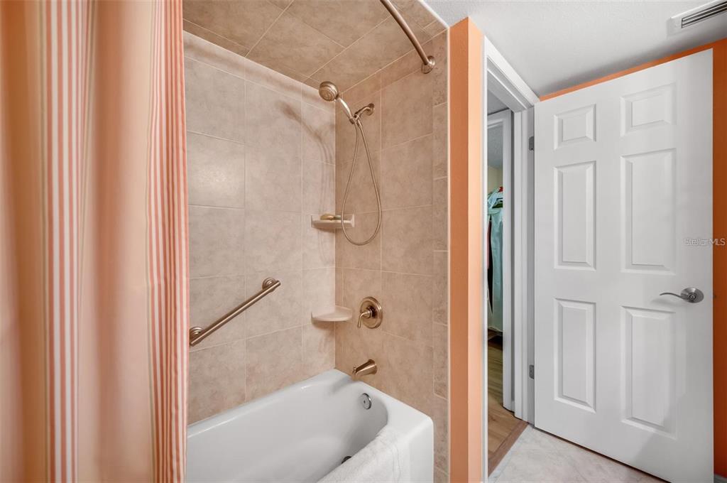 12924 Gulf Boulevard, Unit 510 Madeira Beach, FL 33708 - Photo 37 of 61 a bath room with a shower and a tub