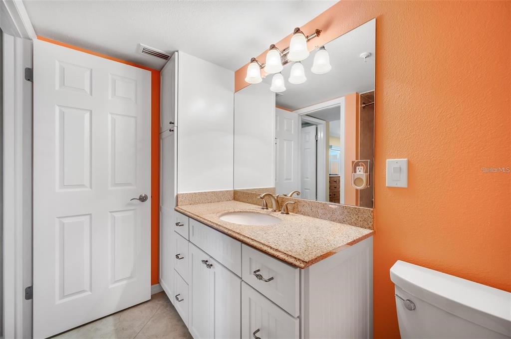 12924 Gulf Boulevard, Unit 510 Madeira Beach, FL 33708 - Photo 38 of 61 a bathroom with a sink and a mirror