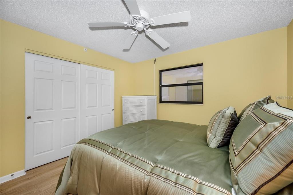 12924 Gulf Boulevard, Unit 510 Madeira Beach, FL 33708 - Photo 39 of 61 a bedroom with a bed and a painting on the wall