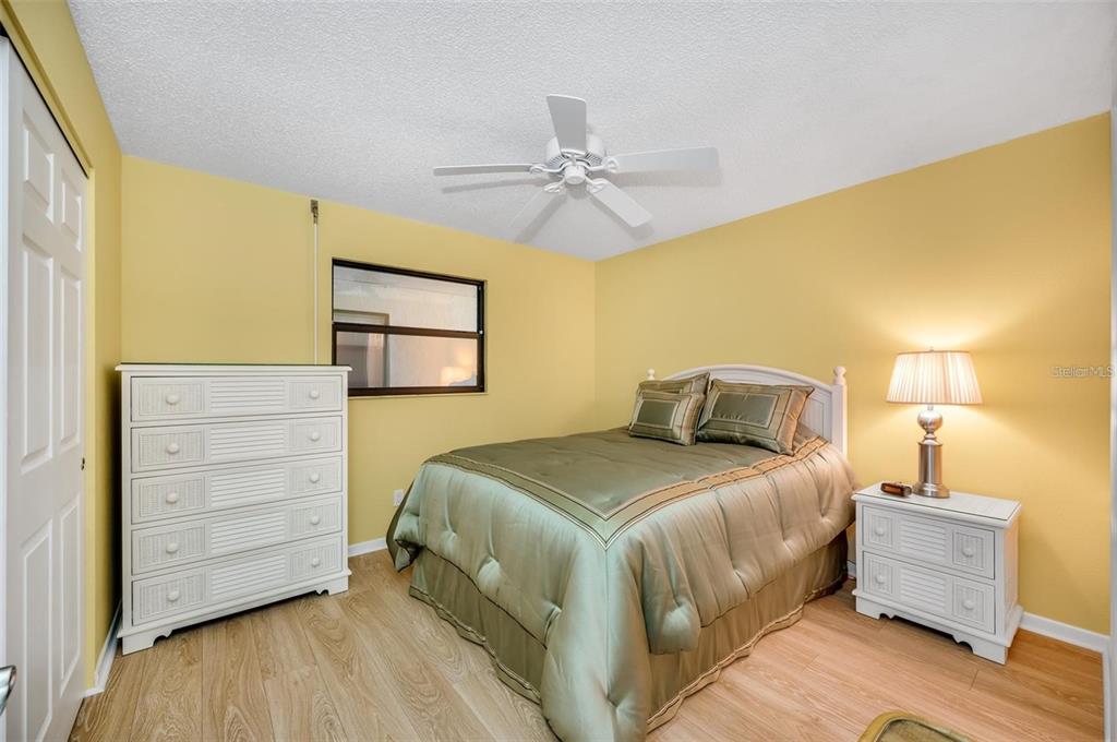 12924 Gulf Boulevard, Unit 510 Madeira Beach, FL 33708 - Photo 40 of 61 a bedroom with a bed and a dresser