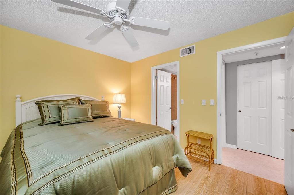 12924 Gulf Boulevard, Unit 510 Madeira Beach, FL 33708 - Photo 41 of 61 a bedroom with a bed and wooden floor