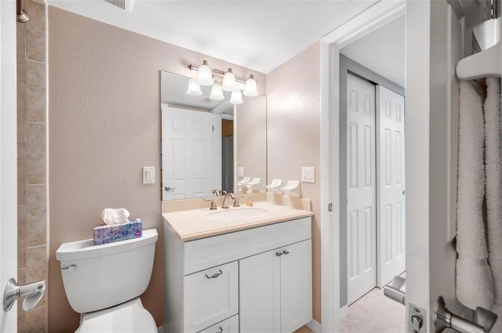 12924 Gulf Boulevard, Unit 510 Madeira Beach, FL 33708 - Photo 44 of 61 a bathroom with a toilet sink and mirror