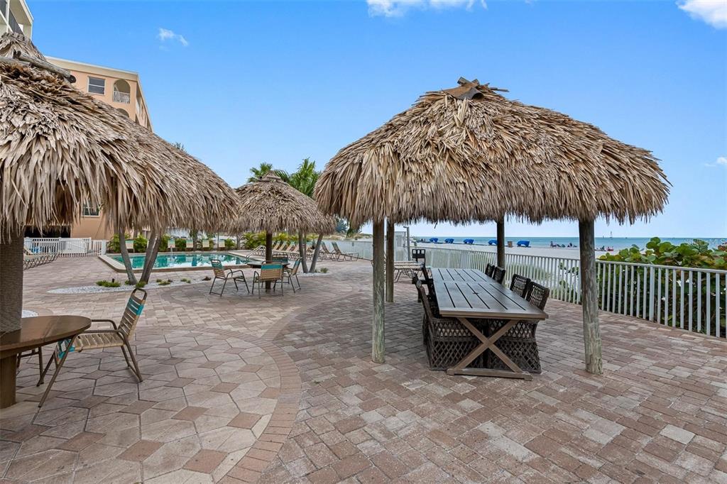 12924 Gulf Boulevard, Unit 510 Madeira Beach, FL 33708 - Photo 49 of 61 a view of a chairs and table under an umbrella