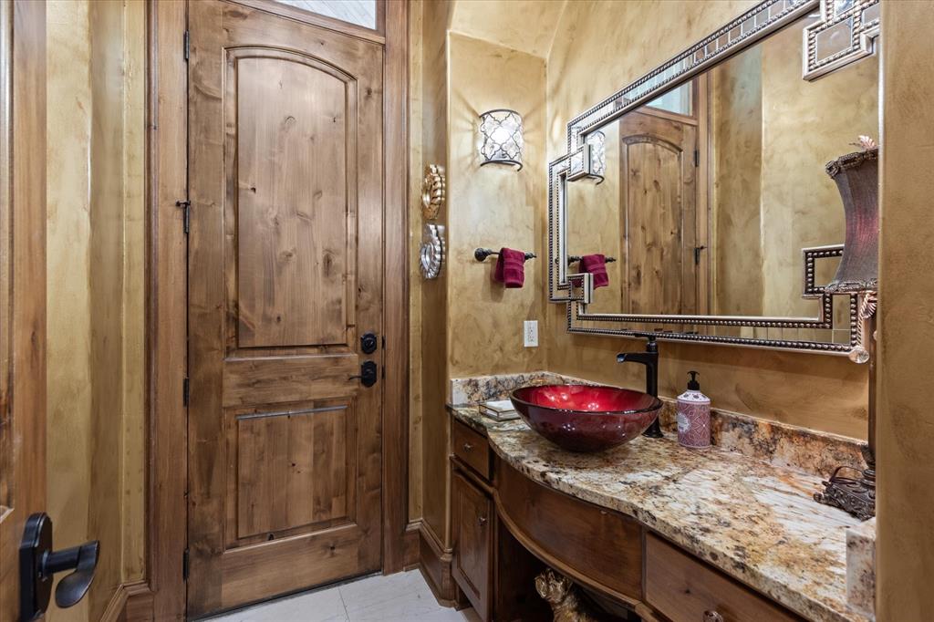 3705 Champions Ridge Lane Longview, TX 75605 - Photo 30 of 40 a bathroom with a granite countertop shower and a sink