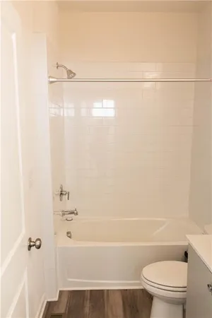 a bathroom with a shower a toilet and sink