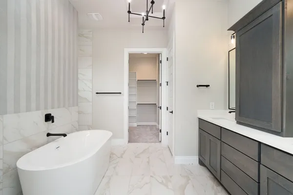 a bathroom with a bathtub and a sink