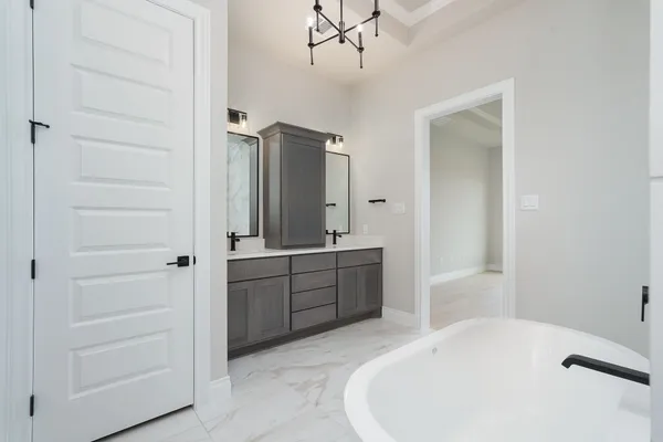a bathroom with a tub sink and mirror