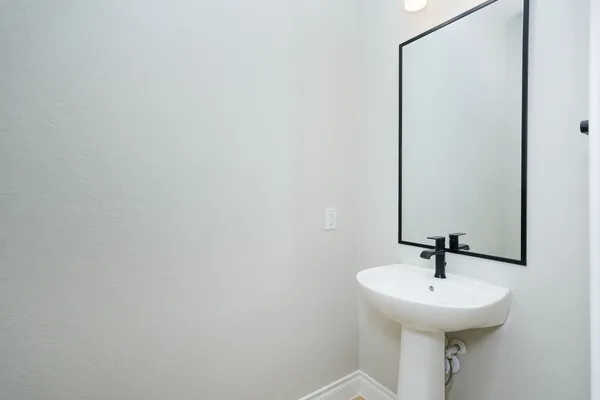 a bathroom with a sink and mirror