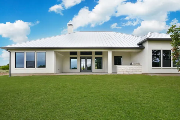 a front view of a house with a garden