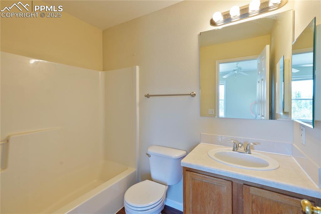 4400 Rawhide Road, Unit 157 Pueblo, CO 81008 - Photo 14 of 19 a bathroom with a sink a toilet and mirror