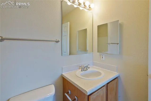 a bathroom with a sink toilet and mirror