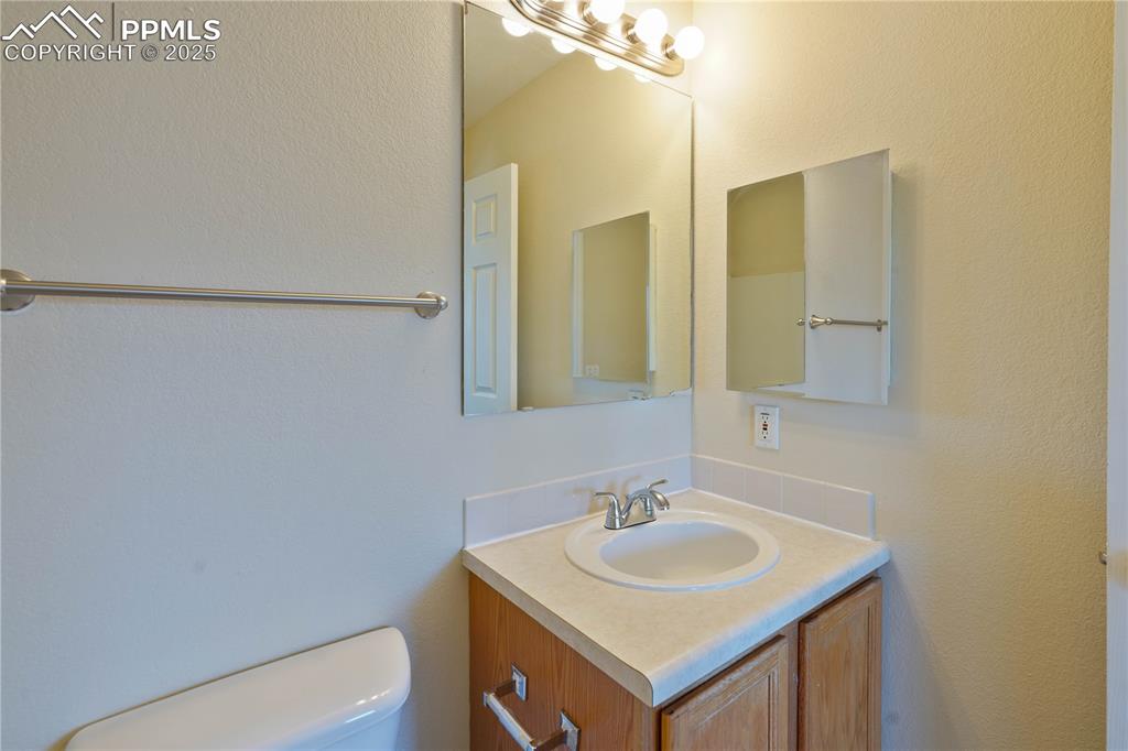 4400 Rawhide Road, Unit 157 Pueblo, CO 81008 - Photo 15 of 19 a bathroom with a sink toilet and mirror