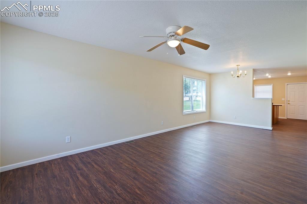 4400 Rawhide Road, Unit 157 Pueblo, CO 81008 - Photo 2 of 19 wooden floor in an empty room with a window