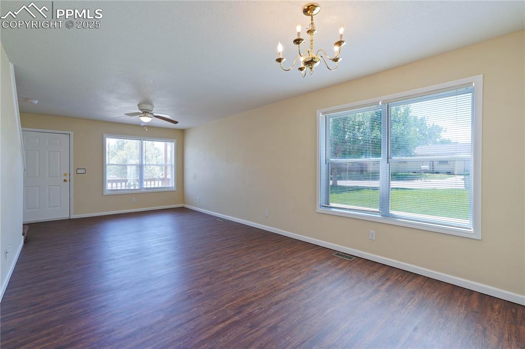 4400 Rawhide Road, Unit 157 Pueblo, CO 81008 - Photo 4 of 19 a view of an empty room with wooden floor and a window