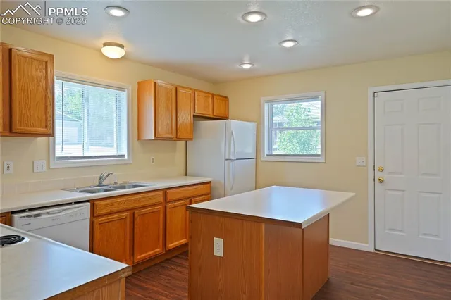 a kitchen that has a sink and a stove in it