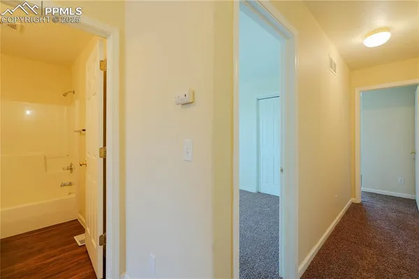 a view of a bathroom from a hallway