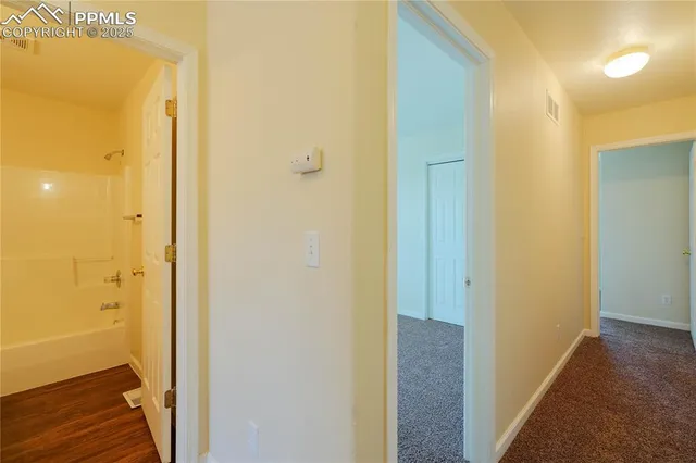 a view of a bathroom from a hallway