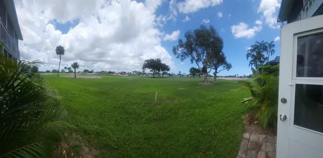 a backyard of a house with lots of green space