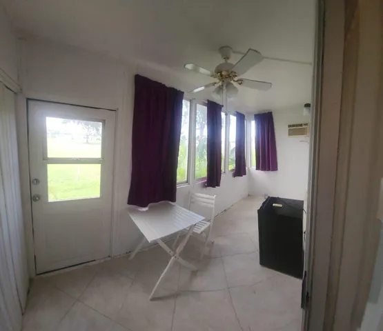 a living room with furniture and a ceiling fan