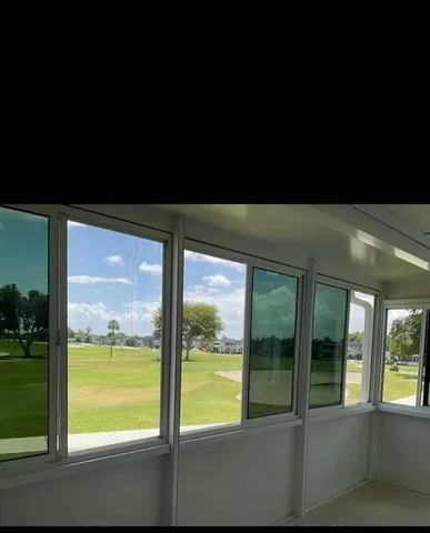 a outdoor view of an empty room with large windows