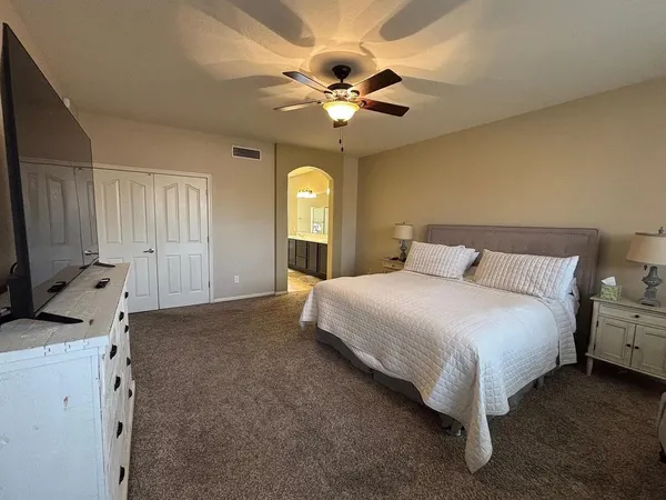 a bedroom with a bed and a chandelier