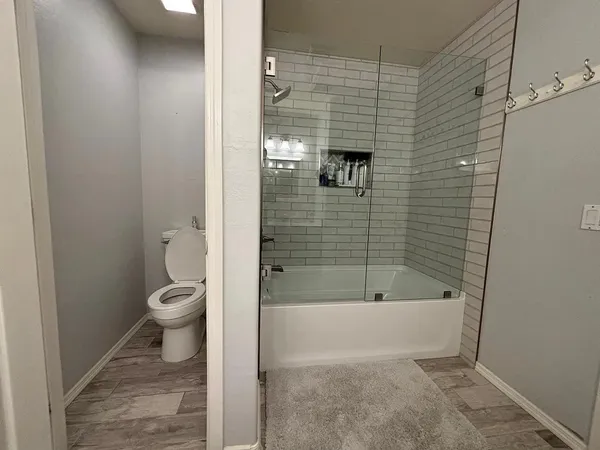 a bathroom with a toilet and a shower