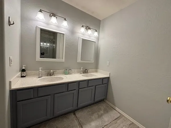 a bathroom with a double vanity sink and a mirror