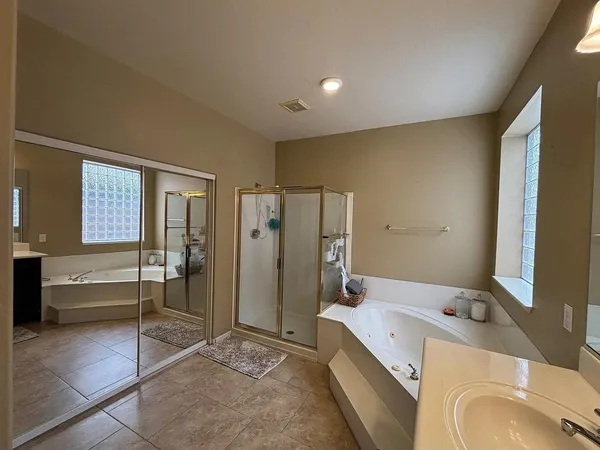 a bathroom with a tub sink and a mirror