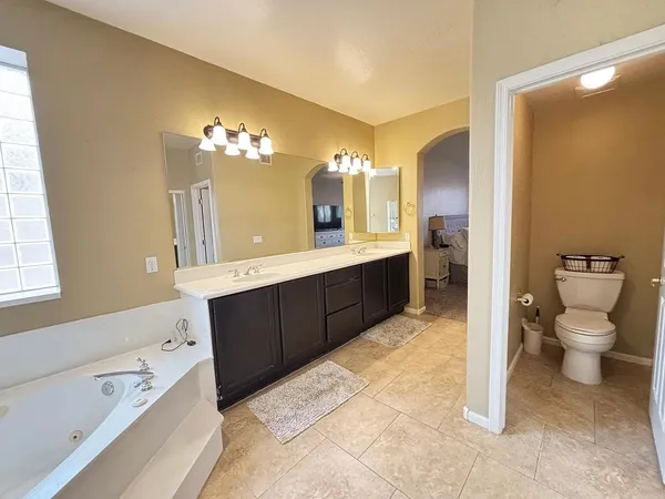 a spacious bathroom with a bathtub sink and a toilet