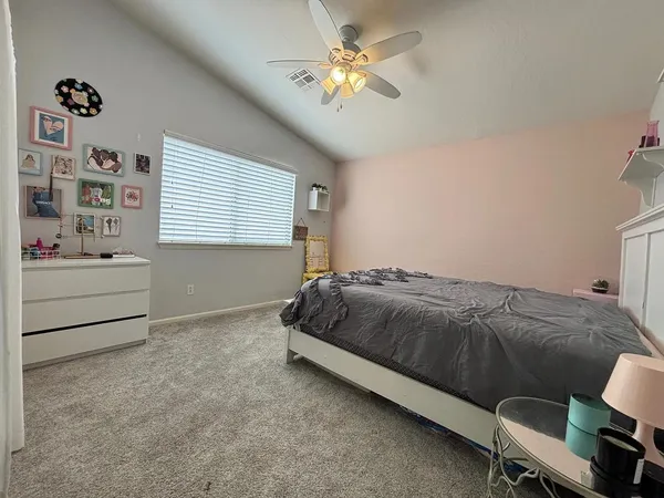 a bedroom with a bed dresser and a window