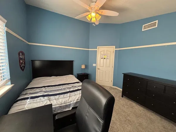 a bedroom with a bed and a dresser