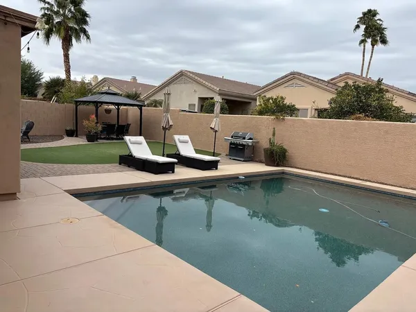 a view of a house with pool and a garden