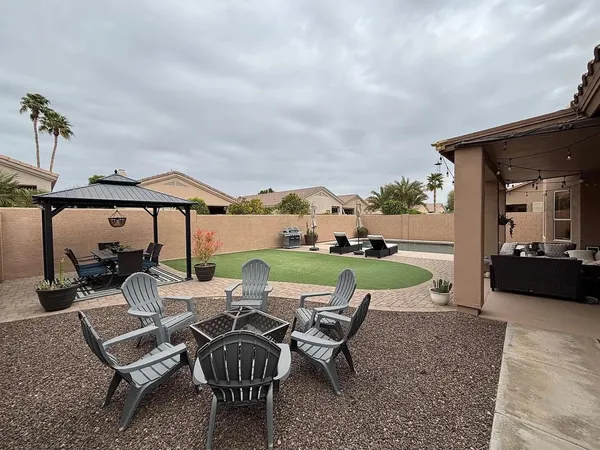 a view of a patio with chairs and table